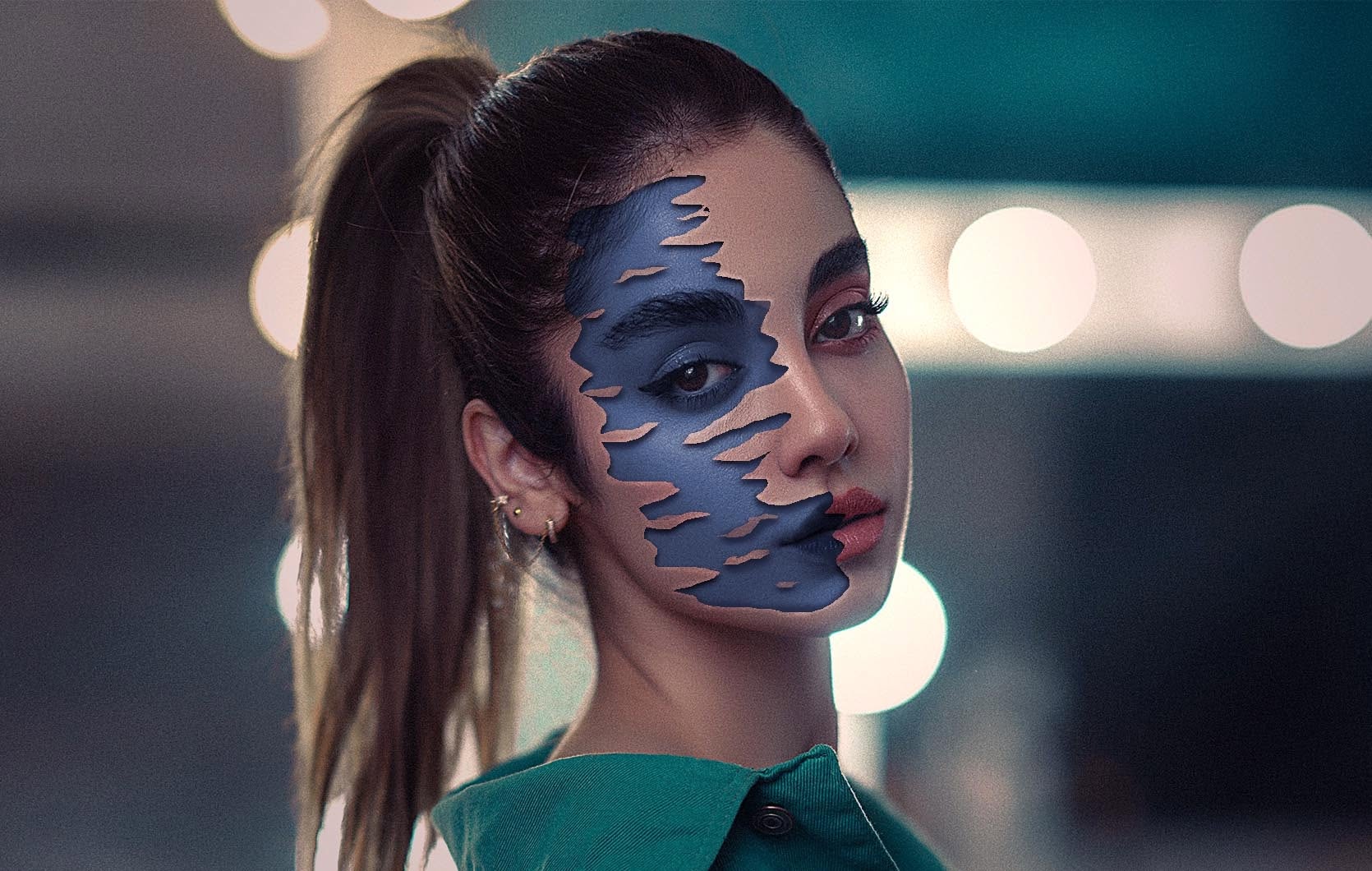 Photo composite: a studio portrait with the skin peeling away to reveal a blue paint layer